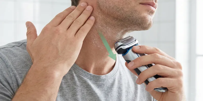 Proper electric shaving technique using light pressure and stretching neck skin