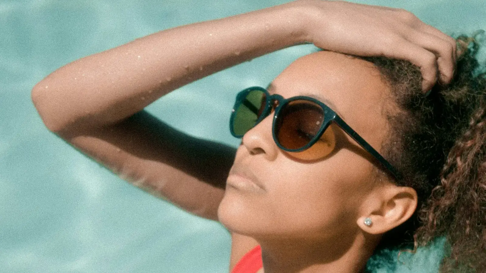 Woman with wet hair after swimming in a pool